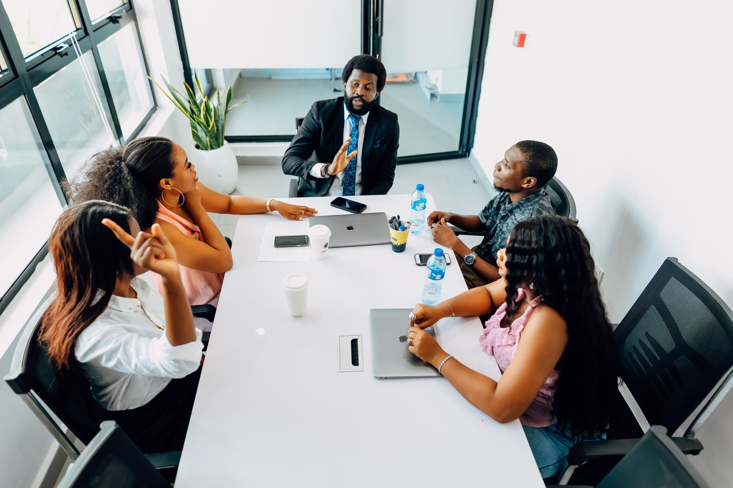 Black African business professionals in a formal boardroom strategy meeting